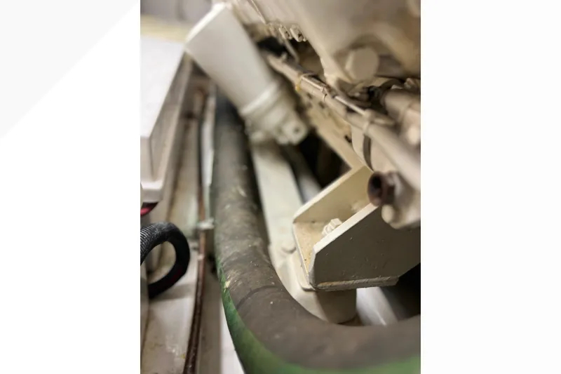 Slide: The Image of Engine compartment of a 1999 Viking 60 CPMY yacht, showing hoses and components. - 148