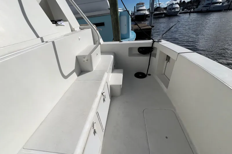 Slide: The Image of 1999 Viking 60 CPMY yacht deck with storage compartments, docked at marina. - 15