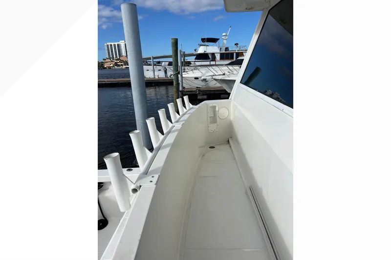 Slide: The Image of 1999 Viking 60 CPMY yacht deck with rod holders, docked at marina. - 19