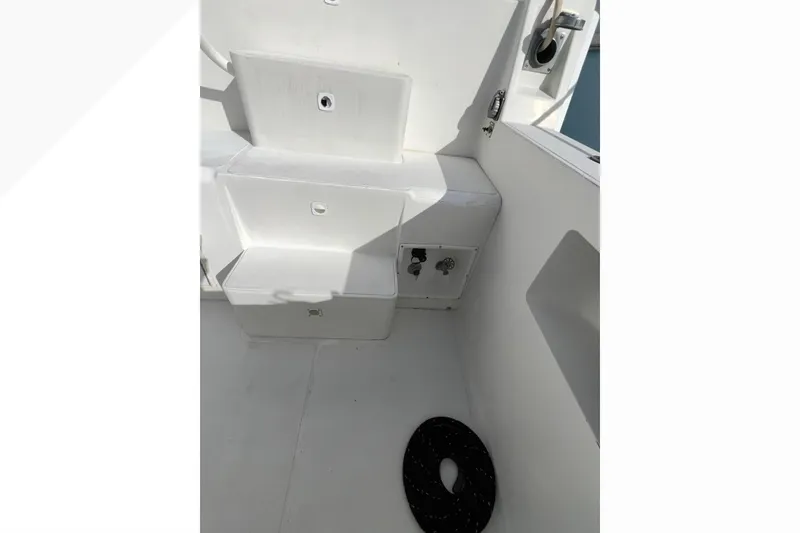 Slide: The Image of 1999 Viking 60 CPMY boat deck with storage compartments and coiled rope. - 20