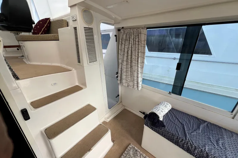 Slide: The Image of Interior of a 1999 Viking 60 CPMY yacht with stairs and seating area. - 37