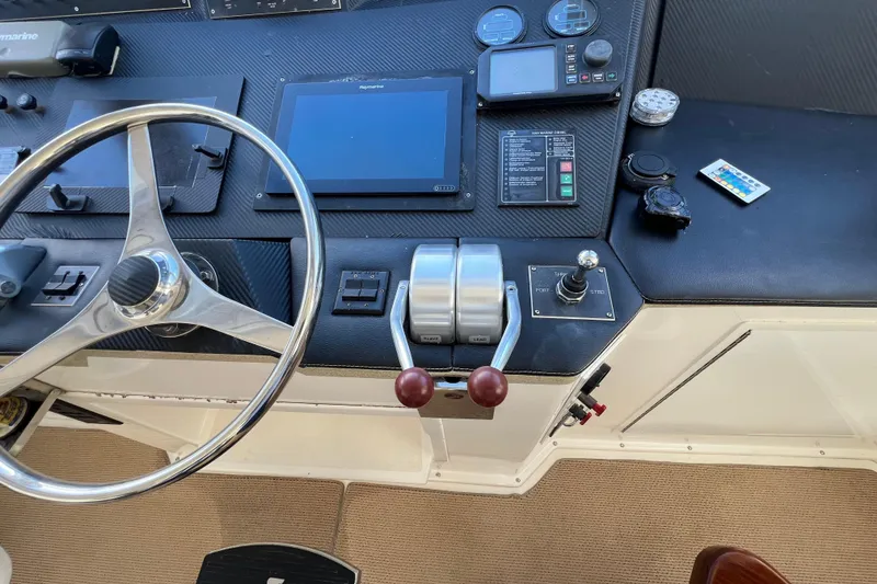 Slide: The Image of Control panel of a 1999 Viking 60 CPMY yacht with steering wheel and navigation instruments. - 45