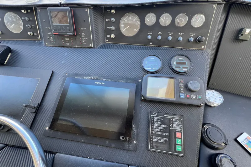 Slide: The Image of Control panel of a 1999 Viking 60 CPMY yacht with navigation instruments and gauges. - 46