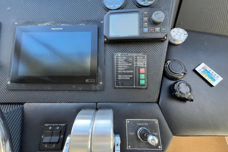 Slide: The Image of Control panel of a 1999 Viking 60 CPMY yacht with navigation and control systems. - 48