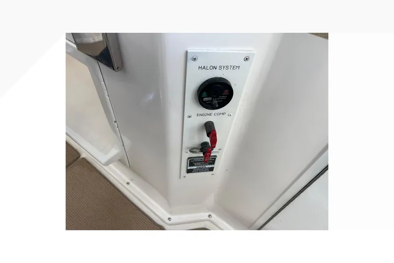 Slide: The Image of Control panel of 1999 Viking 60 CPMY yacht featuring Halon system and engine components. - 49