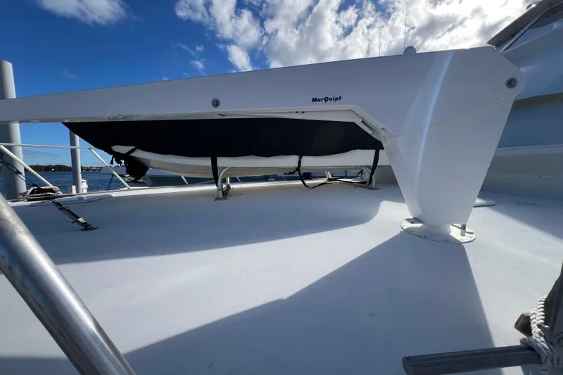 Slide: The Image of 1999 Viking 60 CPMY yacht deck with MarQuipt davit under blue sky. - 5