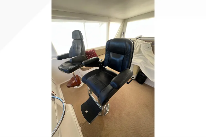 Slide: The Image of Black captain chairs in 1999 Viking 60 CPMY yacht interior. - 54