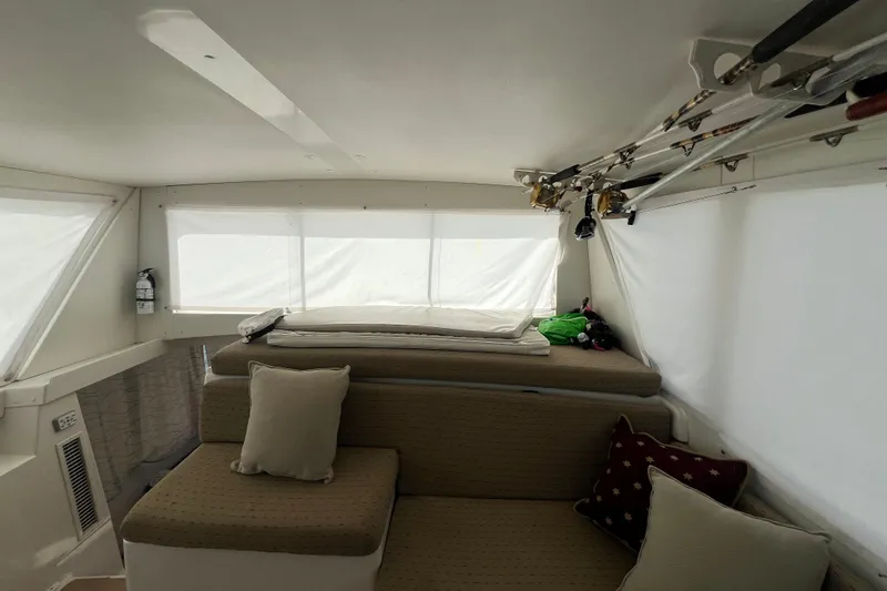 Slide: The Image of Interior of 1999 Viking 60 CPMY yacht with seating and fishing rods. - 55