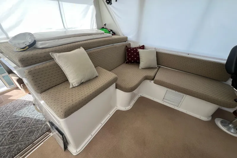 Slide: The Image of Interior seating area of 1999 Viking 60 CPMY yacht with beige cushions and pillows. - 57
