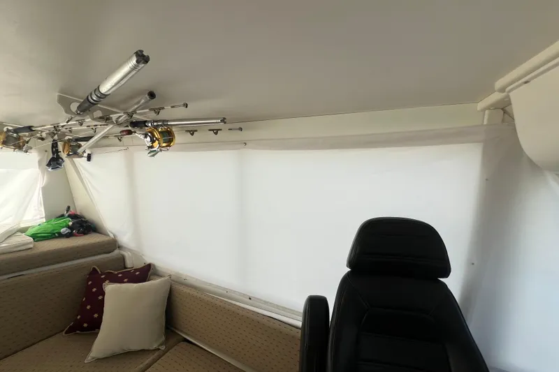 Slide: The Image of Interior of 1999 Viking 60 CPMY yacht with fishing rods and seating area. - 58