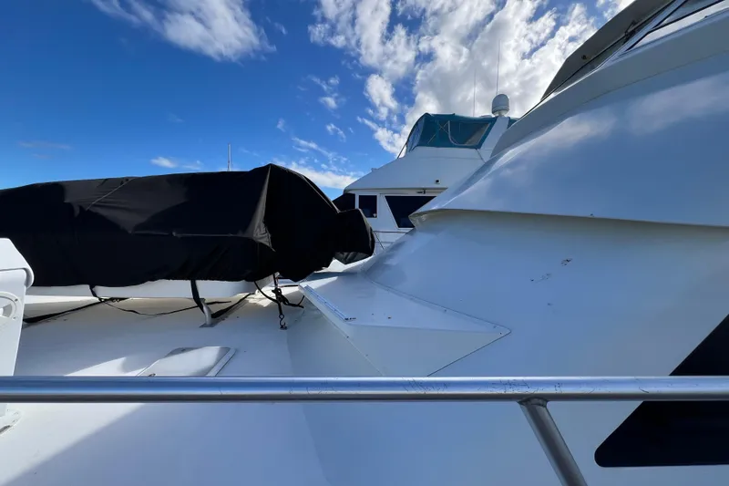 Slide: The Image of 1999 Viking 60 CPMY yacht deck under blue sky with clouds. - 6