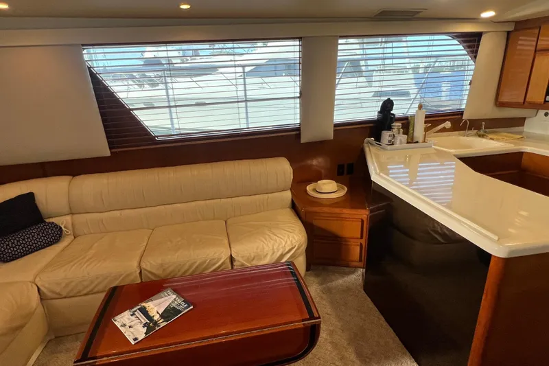 Slide: The Image of Luxurious interior of 1999 Viking 60 CPMY yacht with cream sofa and wooden accents. - 67