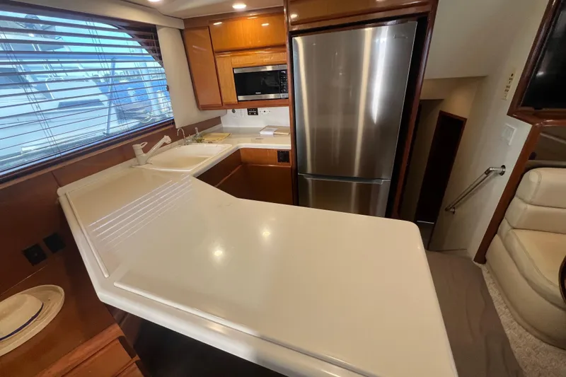 Slide: The Image of Interior of 1999 Viking 60 CPMY yacht kitchen with modern appliances and sleek design. - 69