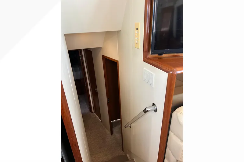 Slide: The Image of Interior stairway of 1999 Viking 60 CPMY yacht with wooden accents. - 75