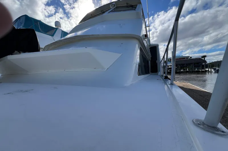 Slide: The Image of 1999 Viking 60 CPMY yacht docked under a cloudy sky. - 8