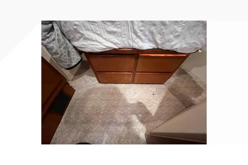 Slide: The Image of Interior of 1999 Viking 60 CPMY yacht with carpet and wooden cabinetry. - 86