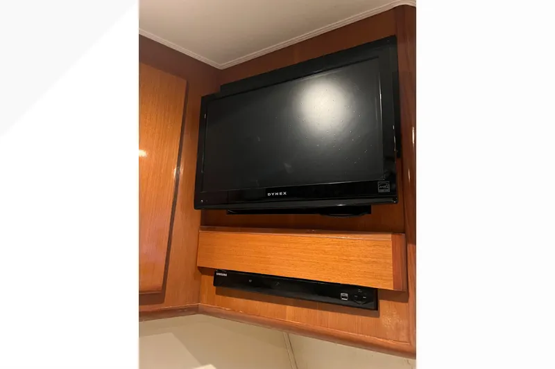 Slide: The Image of Flat-screen TV and DVD player in 1999 Viking 60 CPMY yacht interior. - 87