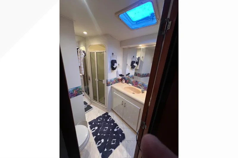 Slide: The Image of Bathroom interior of 1999 Viking 60 CPMY yacht with shower and skylight. - 89