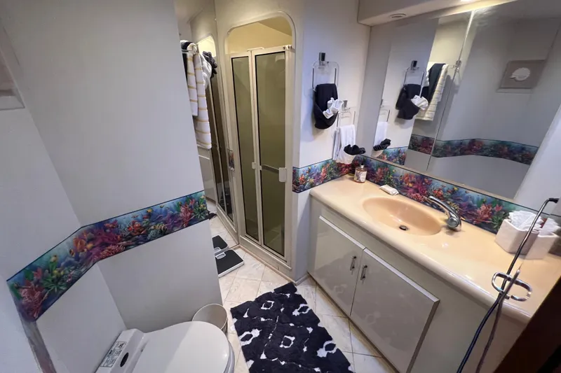 Slide: The Image of Bathroom interior of 1999 Viking 60 CPMY yacht with shower and sink. - 91