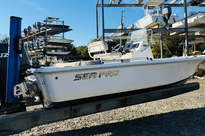 Slide: The Image of 2017 Sea Pro 208 Bay boat on display at a marina with stacked boats. - 3