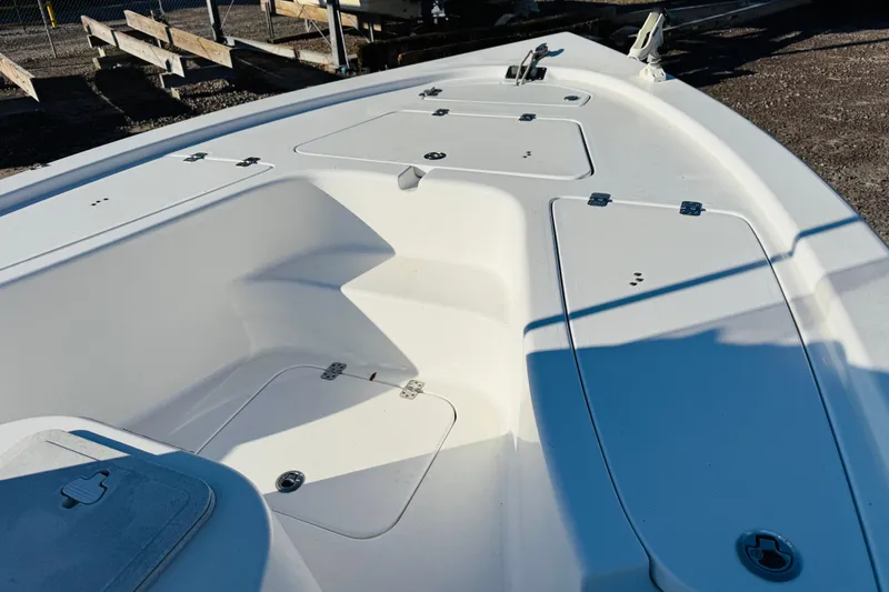 Slide: The Image of 2017 Sea Pro 208 Bay boat deck with storage compartments and clean white finish. - 6