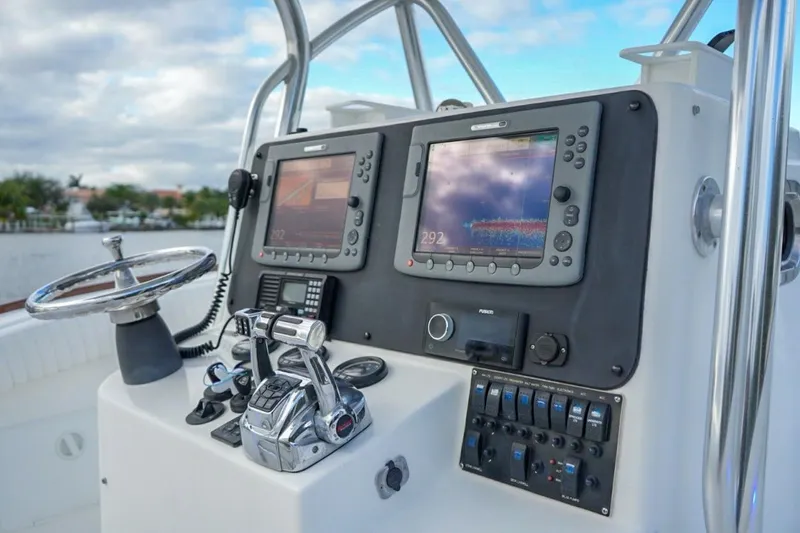 Slide: The Image of 2008 Buddy Davis 28 Center Console boat dashboard with navigation equipment and controls. - 10