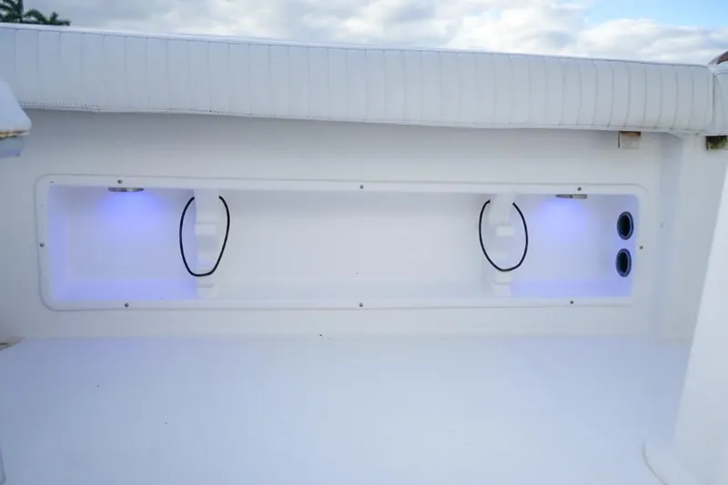 Slide: The Image of 2008 Buddy Davis 28 Center Console boat storage compartment with blue LED lighting. - 13