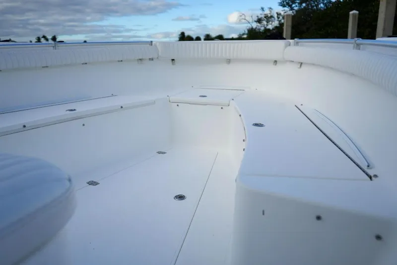 Slide: The Image of 2008 Buddy Davis 28 Center Console boat interior with white seating and storage compartments. - 15