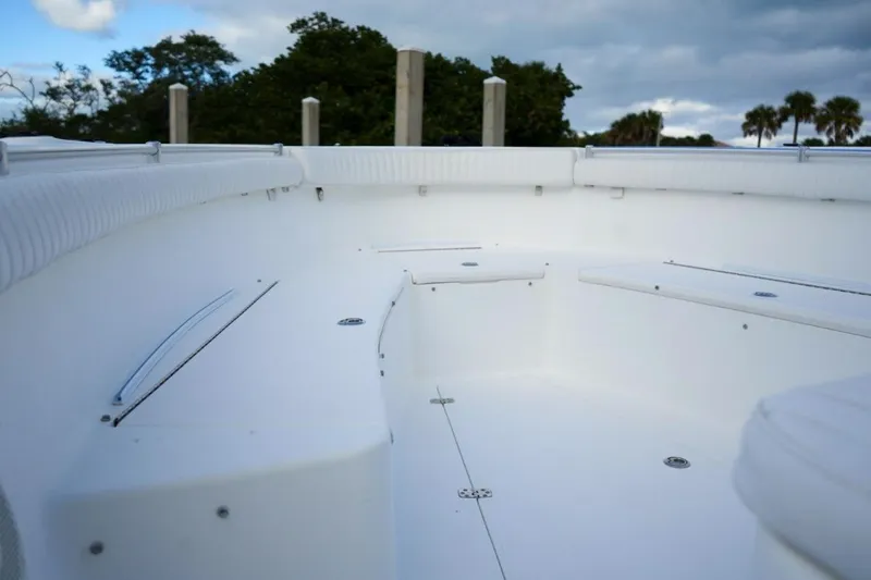 Slide: The Image of 2008 Buddy Davis 28 Center Console boat interior with white seating and open deck. - 16