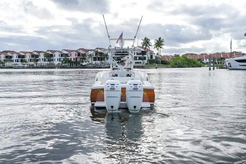 Slide: The Image of 2008 Buddy Davis 28 Center Console boat cruising on a scenic waterfront. - 21