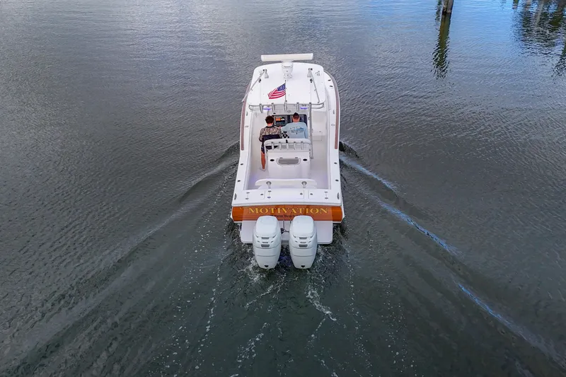 Slide: The Image of 2008 Buddy Davis 28 Center Console boat cruising on calm water, rear view. - 23