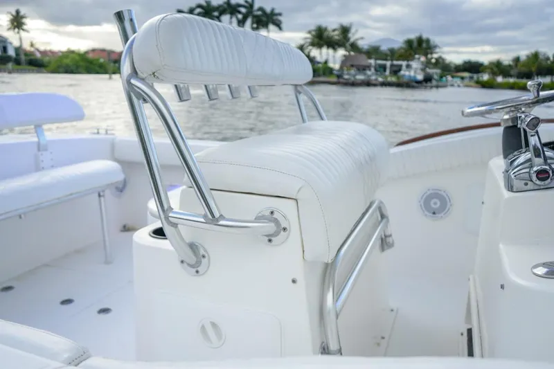 Slide: The Image of 2008 Buddy Davis 28 Center Console boat interior with white seating and chrome details. - 9