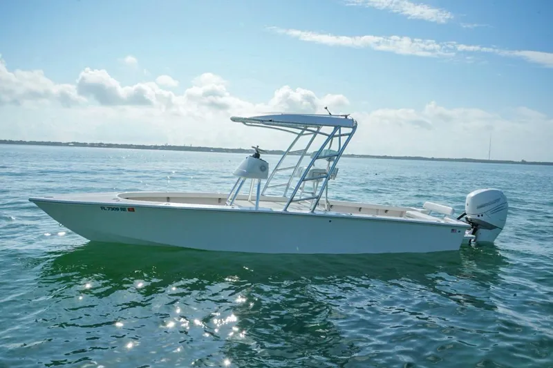 The Image of A 2016 Rambo 27 boat on calm waters under a clear sky. - 0
