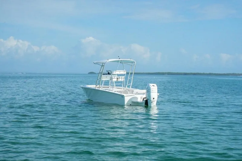 Slide: The Image of White 2016 Rambo 27 boat floating on calm blue ocean waters. - 12