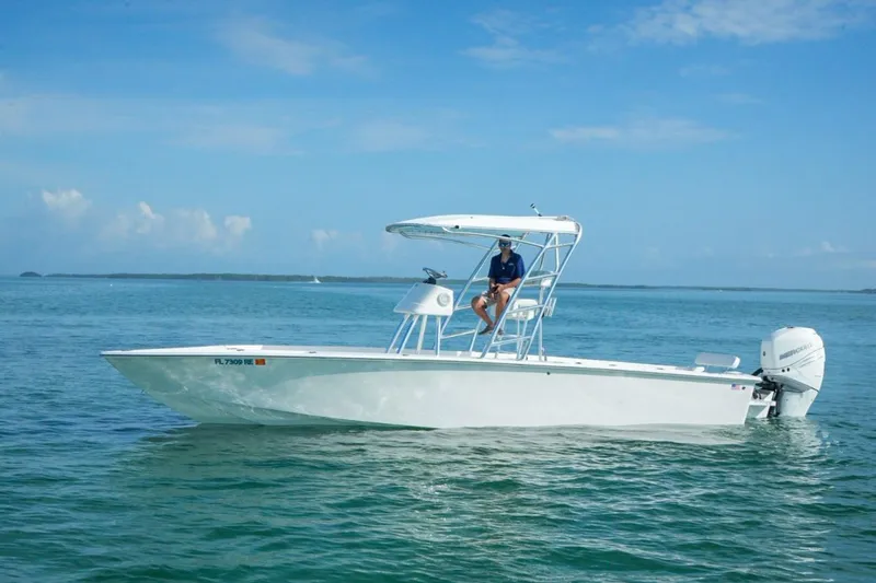 Slide: The Image of 2016 Rambo 27 boat on calm ocean waters under clear blue sky. - 15