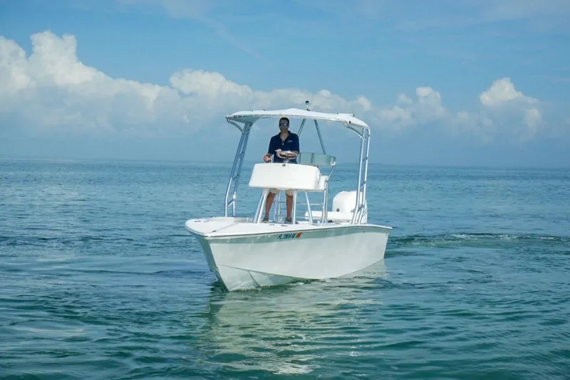 Slide: The Image of 2016 Rambo 27 boat cruising on calm ocean waters under a clear sky. - 16