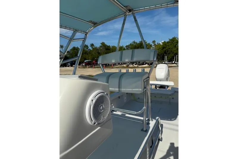 Slide: The Image of Interior of 2016 Rambo 27 boat with seating and speaker, under blue canopy. - 21
