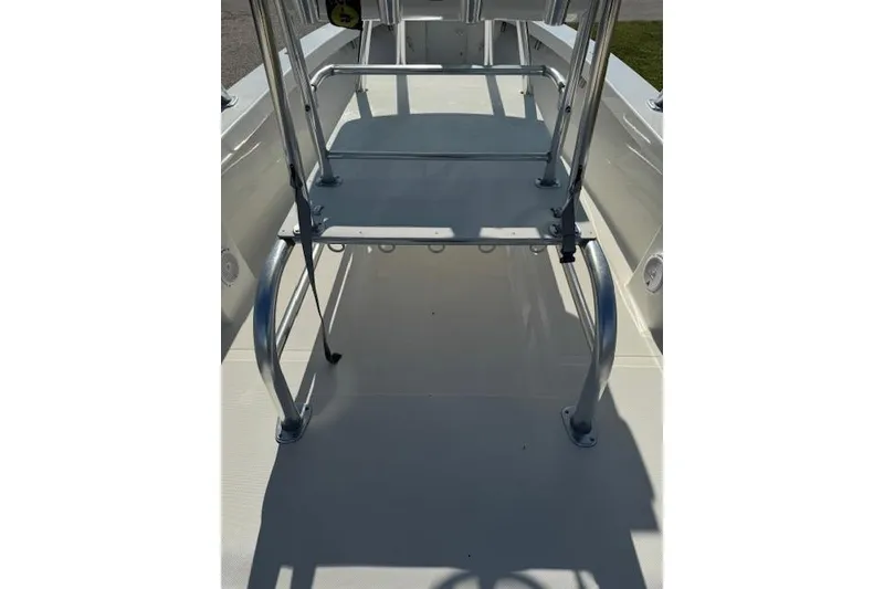 Slide: The Image of 2016 Rambo 27 boat deck with metal railing and seating area. - 27