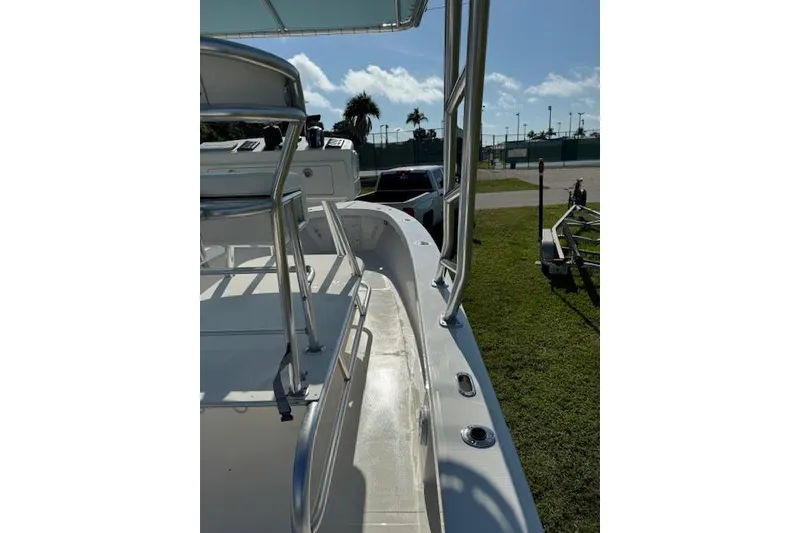 Slide: The Image of 2016 Rambo 27 boat deck with railing, parked on grass under clear sky. - 29
