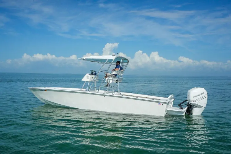 Slide: The Image of 2016 Rambo 27 boat on calm ocean waters under a clear blue sky. - 3