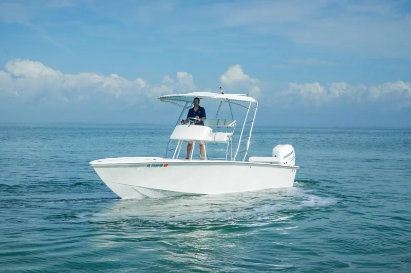 Slide: The Image of White 2016 Rambo 27 boat cruising on calm ocean waters under a clear sky. - 4