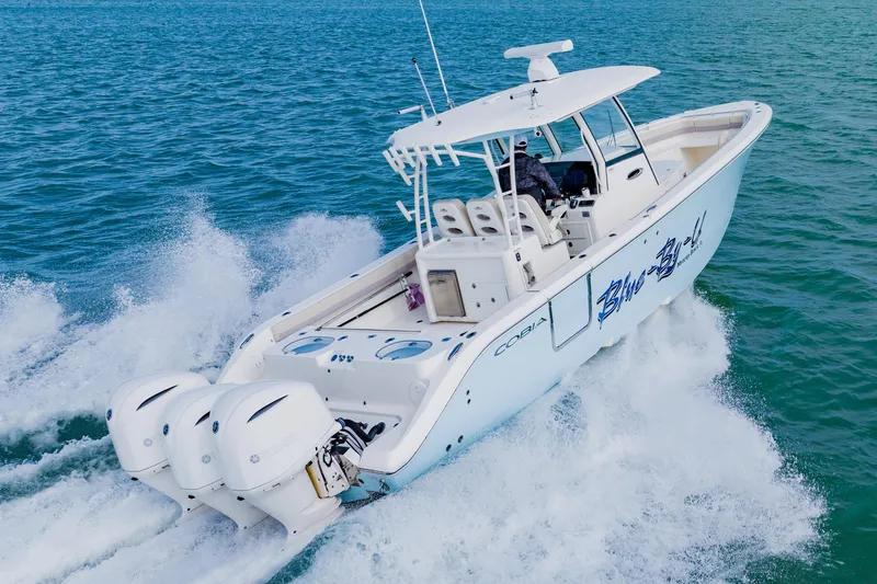 Slide: The Image of 2017 Cobia 344 Center Console boat cruising on open water. - 12