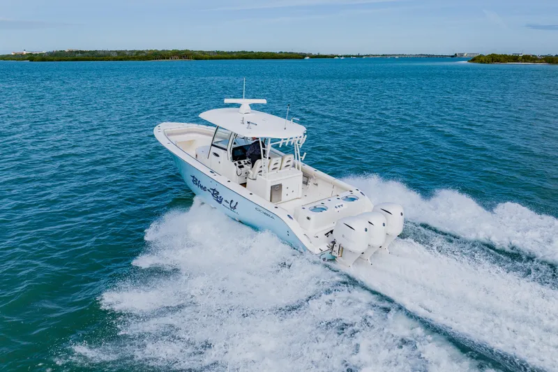 Slide: The Image of 2017 Cobia 344 Center Console boat cruising on open water. - 13