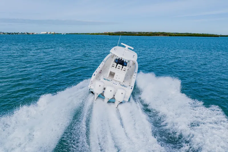 Slide: The Image of 2017 Cobia 344 Center Console boat cruising on open blue water. - 14