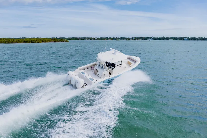Slide: The Image of 2017 Cobia 344 Center Console boat cruising on open water. - 15