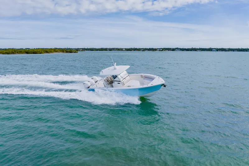 Slide: The Image of 2017 Cobia 344 Center Console boat cruising on open water. - 16