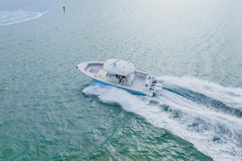 Slide: The Image of 2017 Cobia 344 Center Console boat cruising on open water. - 19