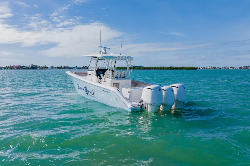 Slide: The Image of 2017 Cobia 344 Center Console boat on turquoise water under blue sky. - 2