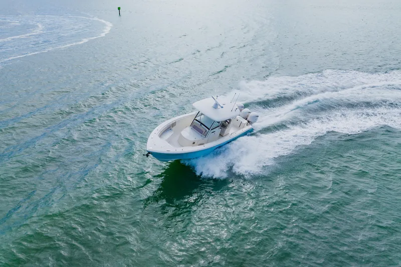 Slide: The Image of 2017 Cobia 344 Center Console boat cruising on open water. - 20