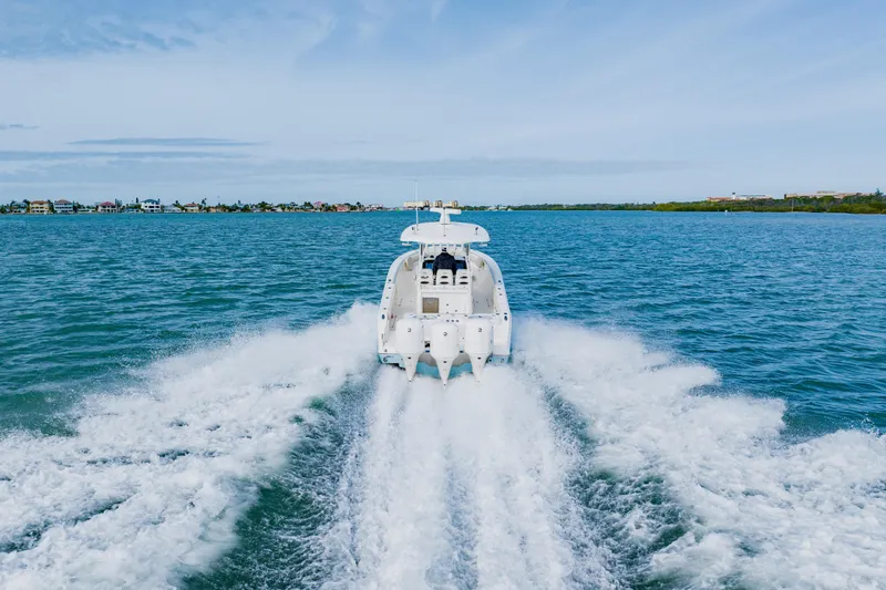 Slide: The Image of 2017 Cobia 344 Center Console boat cruising on open water. - 22